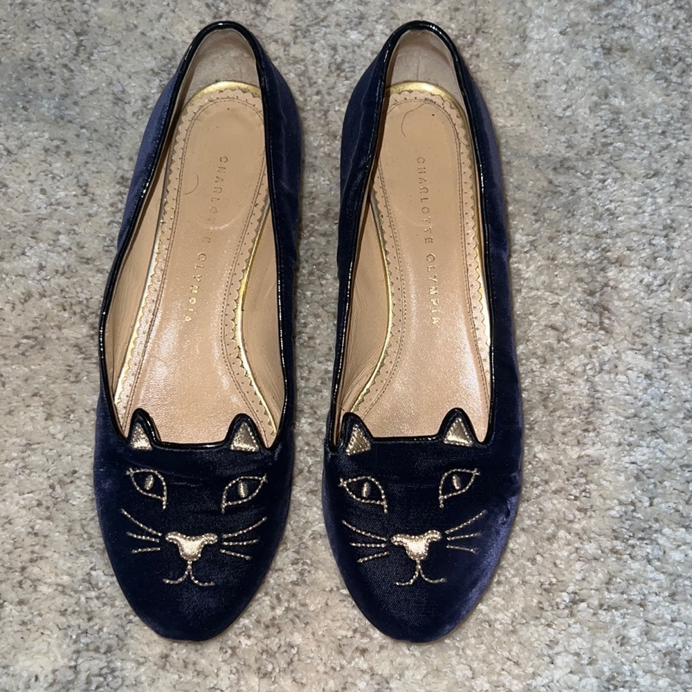 Navy blue suede Charlotte Olympia flats with gold heels.